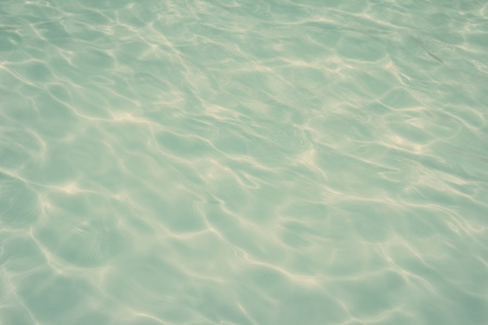 swimming pool with sunny reflections の写真素材
