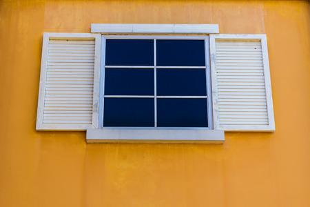 White windows and yellow color wall の写真素材