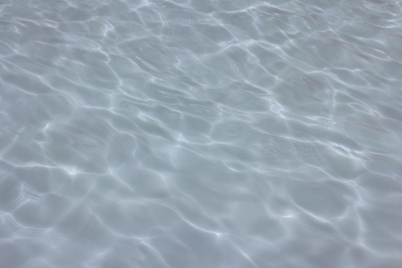 swimming pool with sunny reflections の写真素材