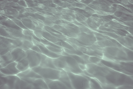 swimming pool with sunny reflections の写真素材
