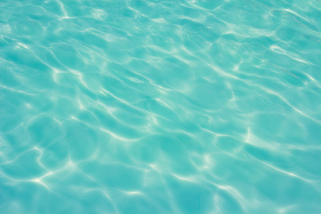 swimming pool with sunny reflections backgroundの写真素材