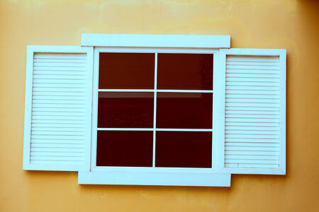 Vintage window on yellow cement wallの写真素材