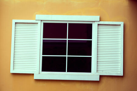 Vintage window on yellow cement wallの写真素材
