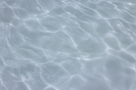 swimming pool with sunny reflections の写真素材