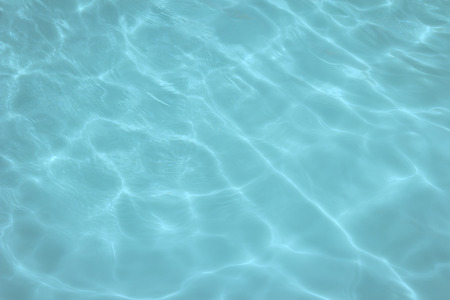 swimming pool with sunny reflections の写真素材
