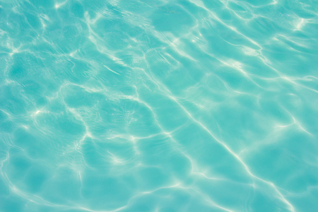 swimming pool with sunny reflections の写真素材