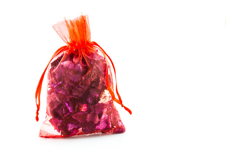 Dried flowers in a red bag on white backgroundの写真素材