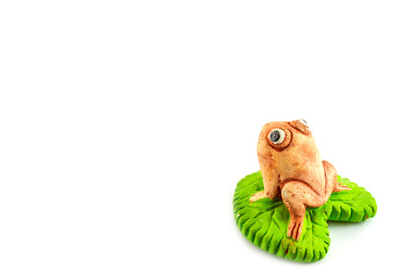Green frog toy on white background for decorate gardenの写真素材