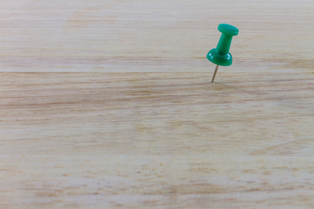 Green pin on the woodの写真素材