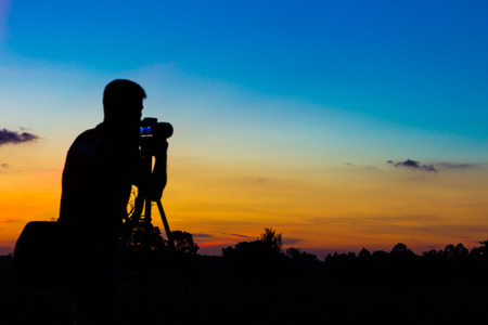 Silhouette photographer with sunset backgroundの写真素材
