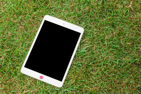 tablet 8.4 inches on green glass background