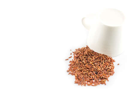 brown rice  close-up and cup on white backgroundの写真素材