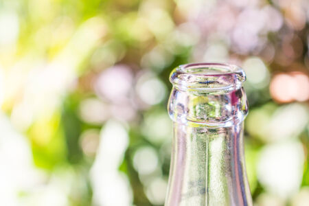 Glass bottle on green bokeh backgroundの写真素材