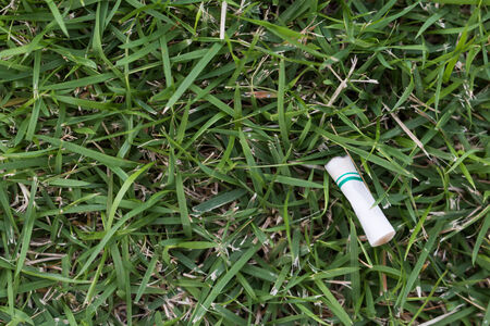cigarette on the grass backgroundの写真素材