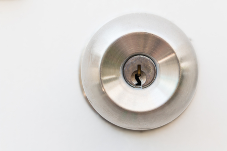 Detail of a Old metallic door knob on white door , stainless steel round ball door knobの写真素材