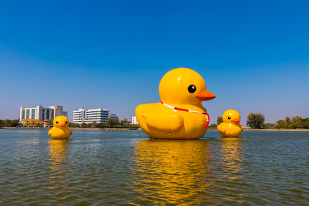 Big yellow duck on the water on blue skyの写真素材
