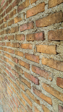 Side view of old orange vintage brick wall backgroundの写真素材