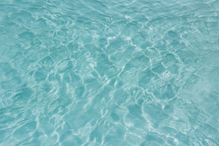 Shining light and reflections of blue water wave texture background