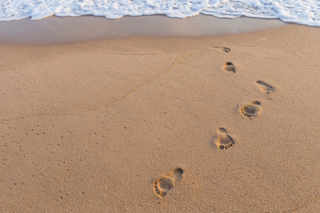 Footprints on the sand beach nature backgroundの写真素材
