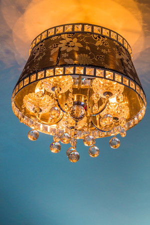 Close-up of a beautiful crystal chandelier with reflectionの写真素材