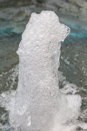 Water stream splashing on the pool backgroundの写真素材