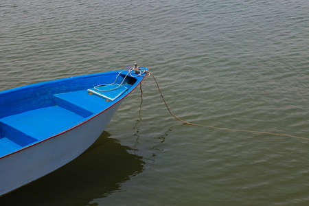 Blue and white old  boat at a the beachの写真素材