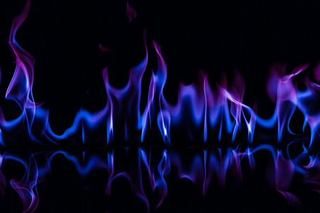 Blue color fire flames on black backgroundの写真素材