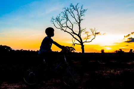 mountainbike silhouette in sunset sky backgroundの写真素材