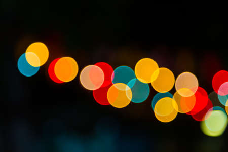 Color Bokeh against a dark backgroundの写真素材