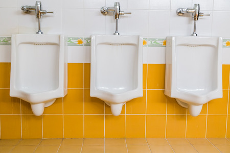 white urinals in men's restroom public toiletsの写真素材