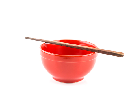 Fresh red bowl with chopsticks isolated on white backgroundの写真素材