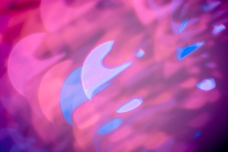 Red, pink, white, yellow and turquoise Chrismas lights bokeh backgroundの写真素材