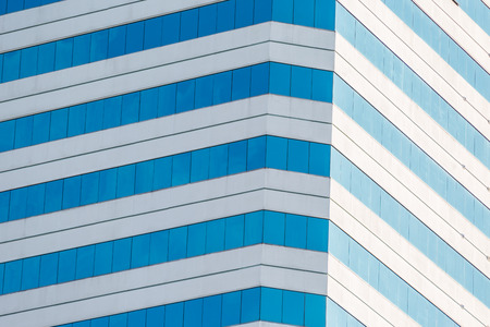 Modern office building with glass reflection backgroundの写真素材