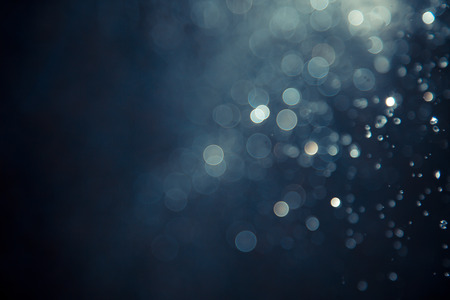 bokeh of water fly and lights on black backgroundの写真素材