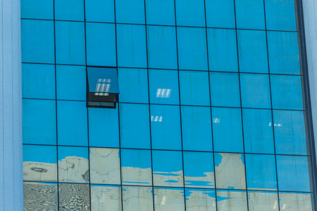 Modern office building with glass reflection backgroundの写真素材