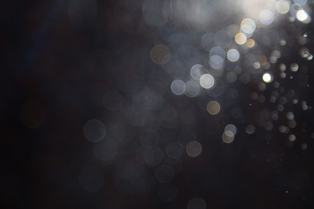 bokeh of water fly and lights on black background