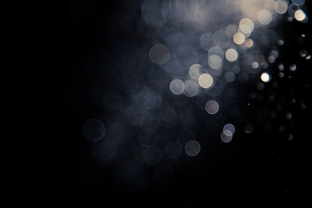 bokeh of water fly and lights on black backgroundの写真素材