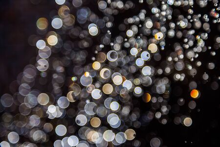 bokeh of water drops levitating in the air reflection with light