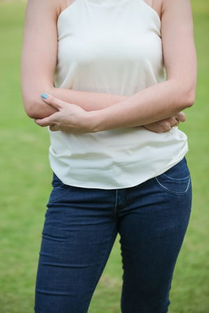 Closeup photo of Women wear blue jeans on green backgroundの写真素材