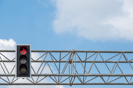Red color turn left on the traffic light with blue sky backgroundの写真素材