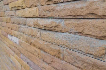 yellow stone wall  made with stone blocks use for background