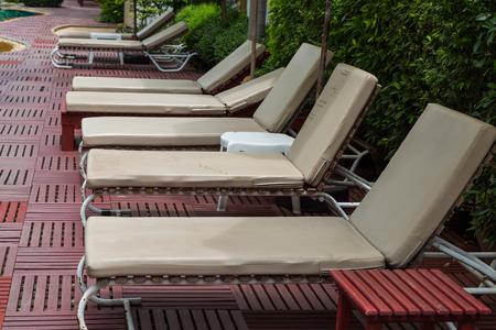 Pool chair side of swimming pool background
