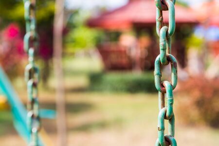 Old Metal Chains with rust on green backgroundの写真素材