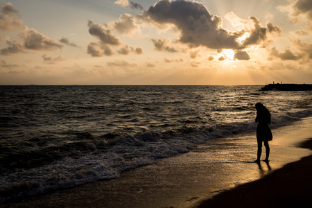 Alone and sad at the beach before sunrise silhouette style backgroundの写真素材