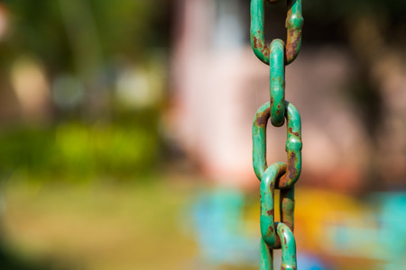 Old Metal Chains with rust on green backgroundの写真素材