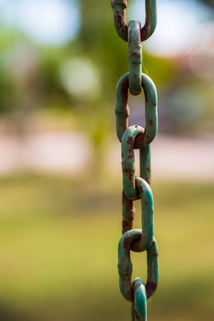 Old Metal Chains with rust on green backgroundの写真素材