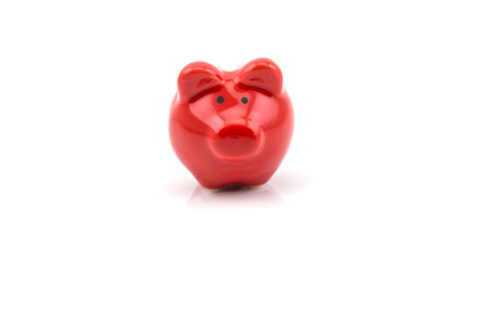 Close up of red piggy bank isolated on white backgroundの写真素材