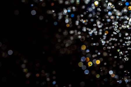 Colorful bokeh on black use for backgroundの写真素材