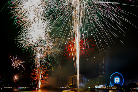 Beautiful firework on the river for celebration on night backgroundの写真素材