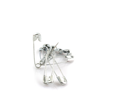 Bunch of safety pins isolated on white backgroundの写真素材